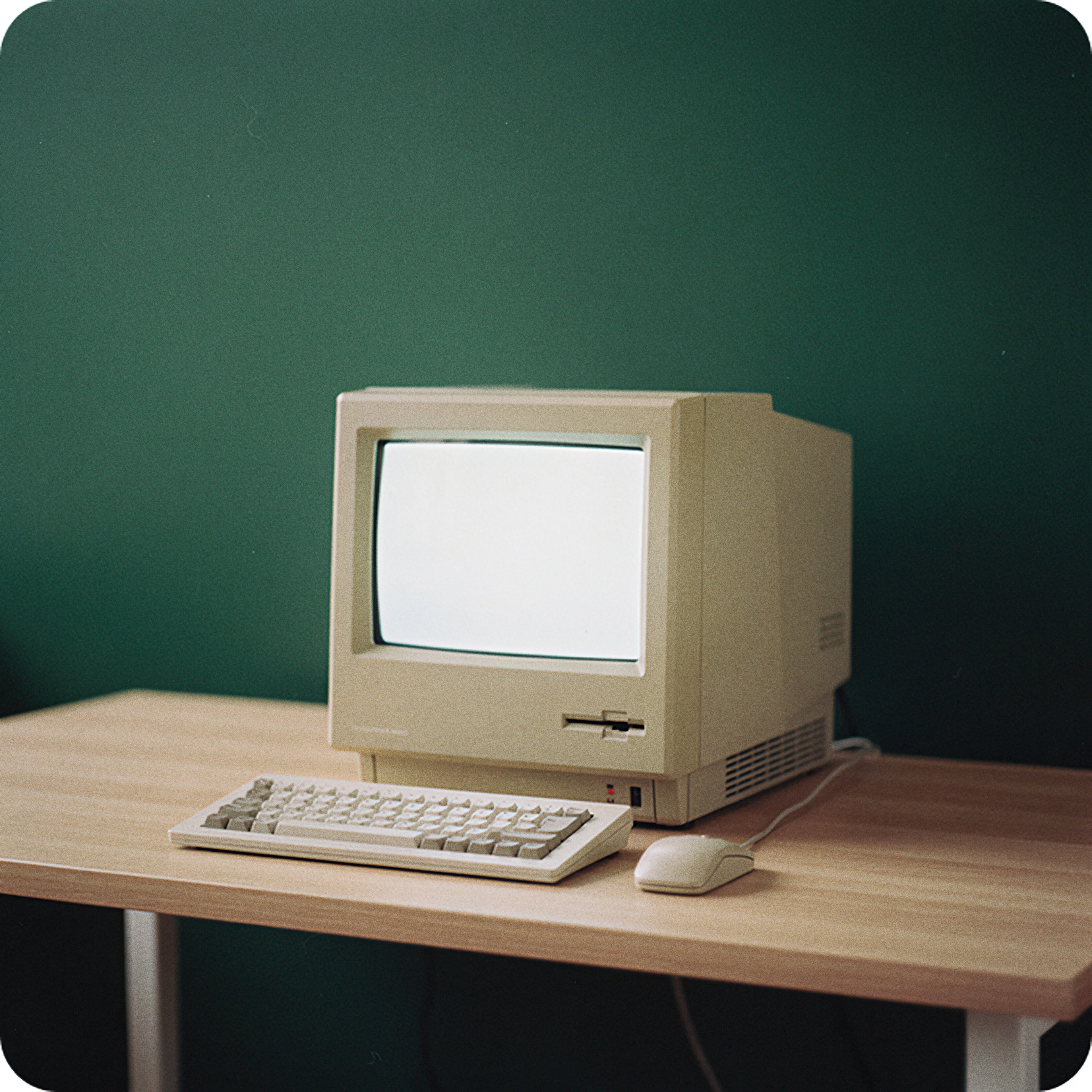 Vintage desktop computer on a wooden desk, representing technology